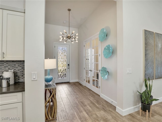 16289 Camden Lakes Cir, Naples, FL 34110 - foyer with light wood finished floors, baseboards, and a chandelier