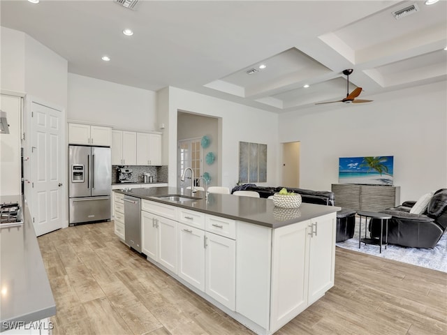16289 Camden Lakes Cir, Naples, FL 34110 - kitchen featuring appliances with stainless steel finishes, a sink, open floor plan, light wood-type flooring, and coffered ceiling