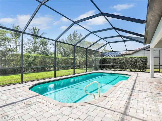 16289 Camden Lakes Cir, Naples, FL 34110 - swimming pool with a patio area, glass enclosure, and a yard