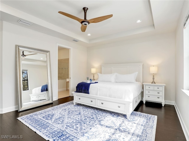 16289 Camden Lakes Cir, Naples, FL 34110 - bedroom featuring dark wood finished floors, baseboards, a raised ceiling, recessed lighting, and ensuite bath