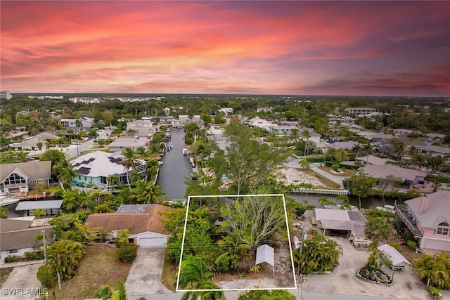 3261 Lakeview Dr, Naples, FL 34112 - aerial view at dusk of property boundaries highlighted and a residential view