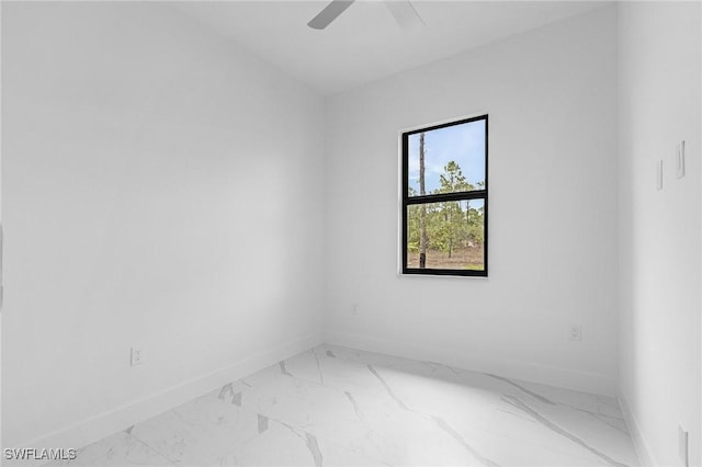 716 David Laird Ln, Lehigh Acres, FL 33974 - spare room featuring light marble finish flooring, baseboards, and ceiling fan