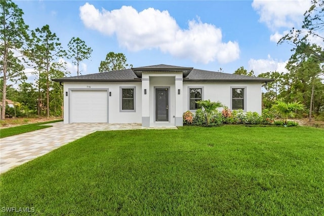 716 David Laird Ln, Lehigh Acres, FL 33974 - prairie-style house with an attached garage, driveway, stucco siding, a front yard, and a shingled roof