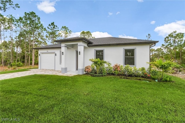 716 David Laird Ln, Lehigh Acres, FL 33974 - prairie-style home with concrete driveway, stucco siding, a garage, and a front yard