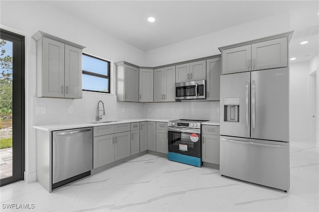 716 David Laird Ln, Lehigh Acres, FL 33974 - kitchen featuring stainless steel appliances, gray cabinets, a sink, light countertops, and recessed lighting