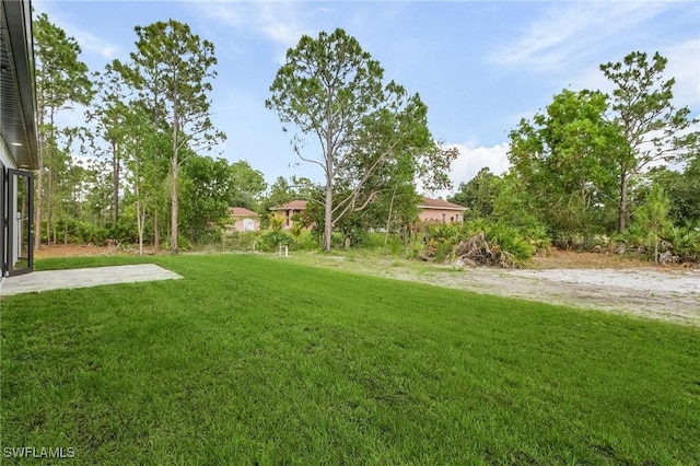716 David Laird Ln, Lehigh Acres, FL 33974 - view of green lawn featuring a patio area