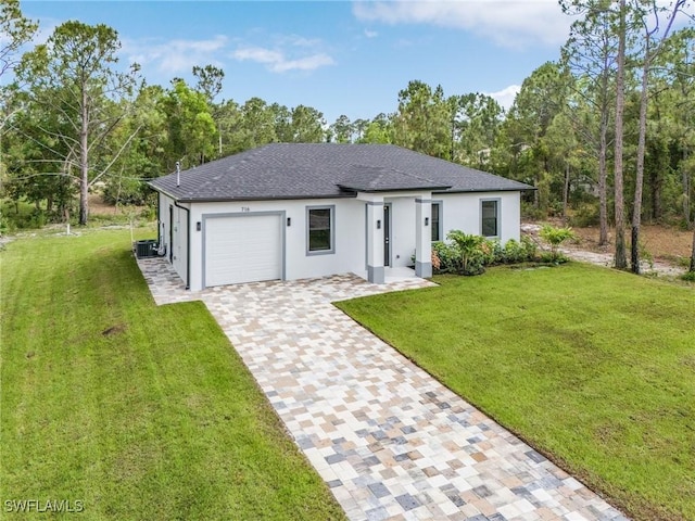 716 David Laird Ln, Lehigh Acres, FL 33974 - view of front of house with an attached garage, stucco siding, decorative driveway, and a front lawn