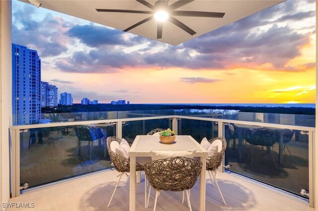 6897 Grenadier Blvd Unit 601, Naples, FL 34108 - balcony at dusk with a view of city and ceiling fan