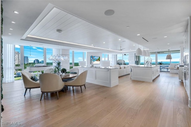 6897 Grenadier Blvd Unit 601, Naples, FL 34108 - dining room with light wood-style flooring, floor to ceiling windows, and a chandelier