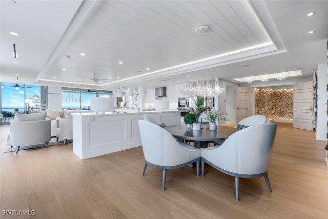 6897 Grenadier Blvd Unit 601, Naples, FL 34108 - dining space with a raised ceiling, light wood finished floors, a ceiling fan, and recessed lighting
