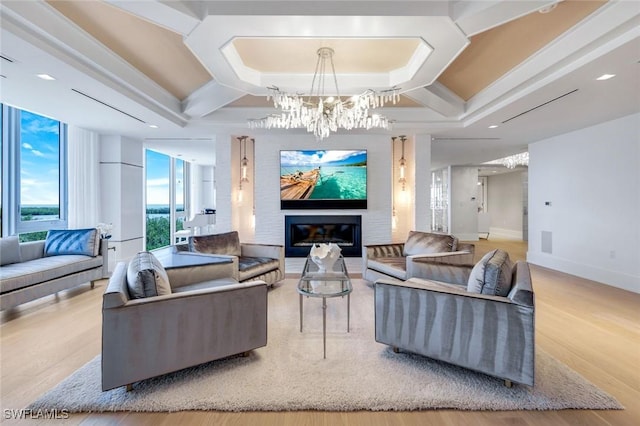 6897 Grenadier Blvd Unit 601, Naples, FL 34108 - living room with coffered ceiling, wood finished floors, a large fireplace, a chandelier, and beam ceiling