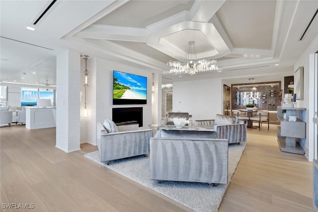 6897 Grenadier Blvd Unit 601, Naples, FL 34108 - living area with light wood-type flooring, a fireplace, and a chandelier