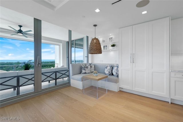 6897 Grenadier Blvd Unit 601, Naples, FL 34108 - dining space with light wood-type flooring, a ceiling fan, and french doors