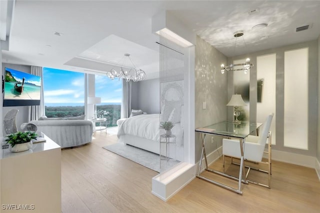 6897 Grenadier Blvd Unit 601, Naples, FL 34108 - bedroom featuring a chandelier, wood finished floors, and a wall of windows