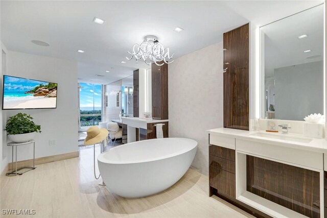 6897 Grenadier Blvd Unit 601, Naples, FL 34108 - full bathroom with a soaking tub, a chandelier, vanity, and baseboards