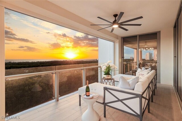 6897 Grenadier Blvd Unit 601, Naples, FL 34108 - balcony at dusk with a ceiling fan and outdoor lounge area