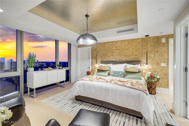 6897 Grenadier Blvd Unit 601, Naples, FL 34108 - bedroom featuring a raised ceiling and wood finished floors