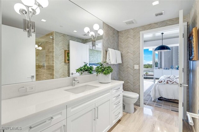 6897 Grenadier Blvd Unit 601, Naples, FL 34108 - full bath with toilet, vanity, ensuite bath, tile walls, and tiled shower