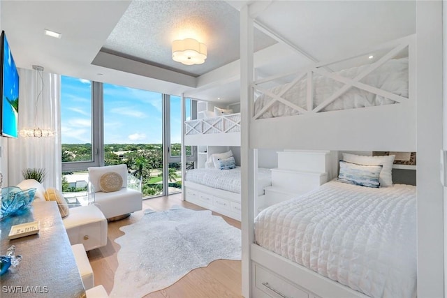 6897 Grenadier Blvd Unit 601, Naples, FL 34108 - bedroom featuring expansive windows and wood finished floors