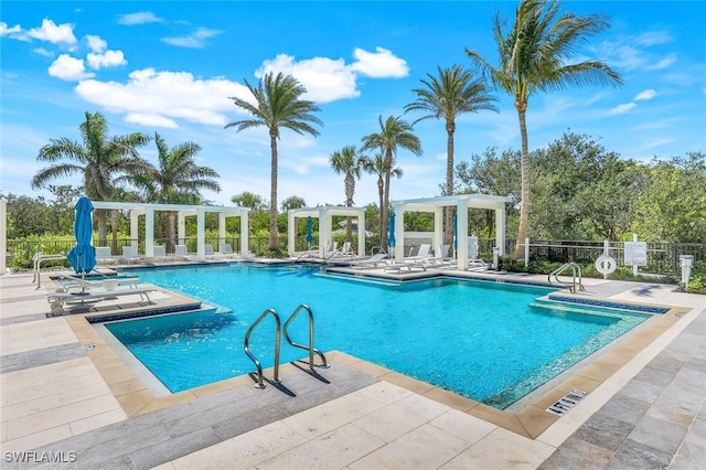 6897 Grenadier Blvd Unit 601, Naples, FL 34108 - community pool featuring a pergola, fence, and a patio area