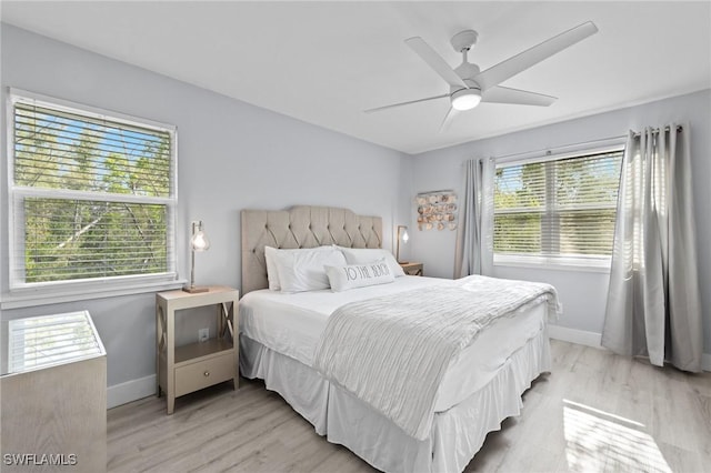 222 Mango St, Fort Myers Beach, FL 33931 - bedroom featuring multiple windows, light wood-type flooring, and baseboards