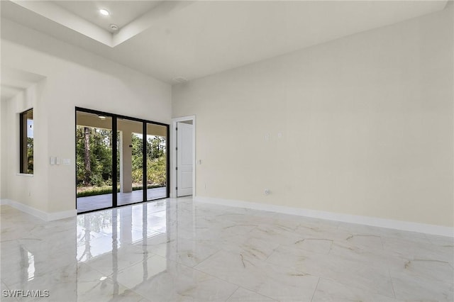 956 Columbus Blvd S, Lehigh Acres, FL 33974 - unfurnished room with light marble finish floors, baseboards, a towering ceiling, and recessed lighting