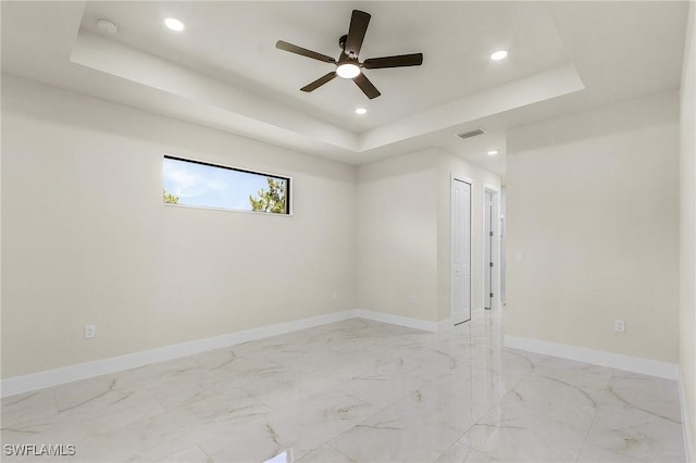 956 Columbus Blvd S, Lehigh Acres, FL 33974 - spare room featuring a raised ceiling, ceiling fan, recessed lighting, baseboards, and light marble finish flooring