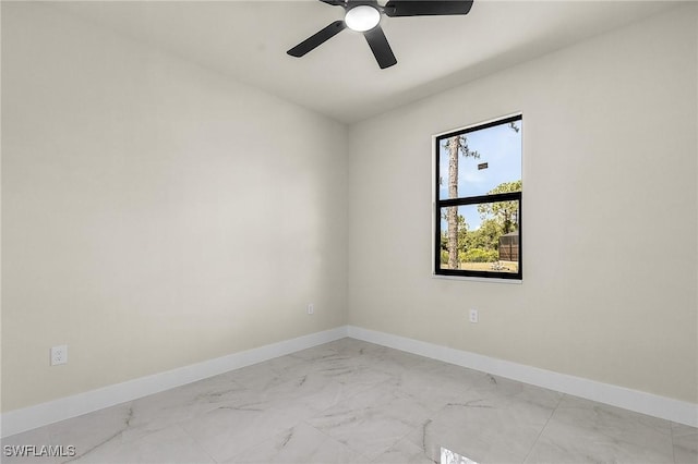 956 Columbus Blvd S, Lehigh Acres, FL 33974 - empty room featuring light marble finish floors, baseboards, and ceiling fan