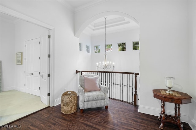 10692 Mirasol Dr Unit 1004, Miromar Lakes, FL 33913 - living area featuring a chandelier, wood finished floors, arched walkways, crown molding, and baseboards
