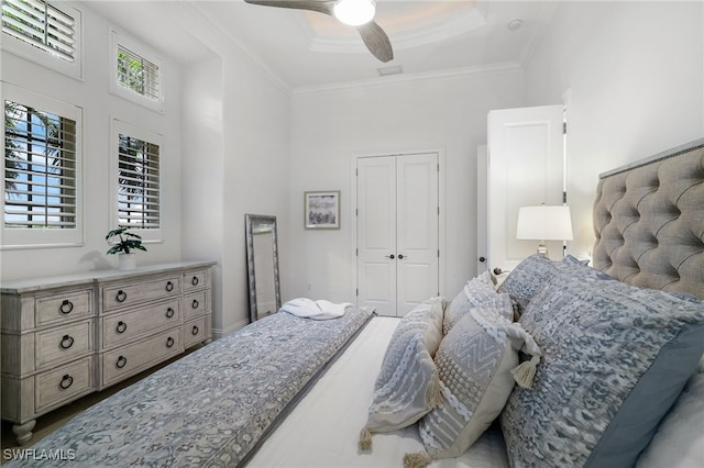 10692 Mirasol Dr Unit 1004, Miromar Lakes, FL 33913 - bedroom featuring ornamental molding, a closet, ceiling fan, a high ceiling, and a tray ceiling