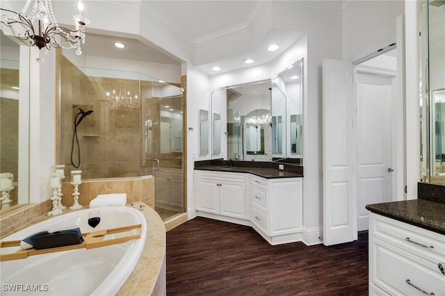 10692 Mirasol Dr Unit 1004, Miromar Lakes, FL 33913 - bathroom featuring a chandelier, ornamental molding, a garden tub, a shower stall, and vanity