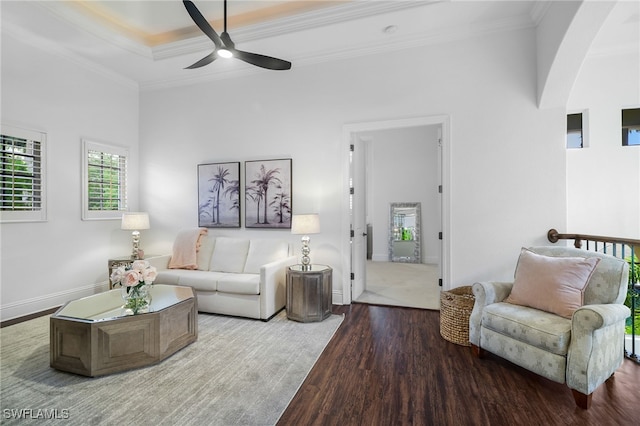 10692 Mirasol Dr Unit 1004, Miromar Lakes, FL 33913 - living area featuring wood finished floors, arched walkways, ceiling fan, crown molding, and baseboards