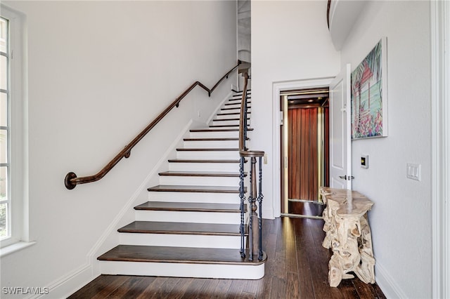 10692 Mirasol Dr Unit 1004, Miromar Lakes, FL 33913 - stairway featuring elevator, wood finished floors, and baseboards