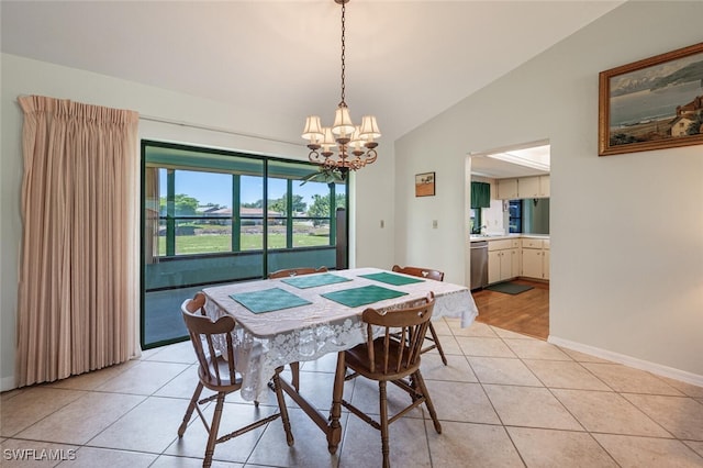 938 Charlemagne Blvd, Naples, FL 34112 - dining room featuring a chandelier, light tile patterned flooring, vaulted ceiling, and baseboards