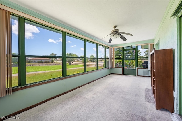 938 Charlemagne Blvd, Naples, FL 34112 - unfurnished sunroom featuring a ceiling fan, carpet flooring, and baseboards