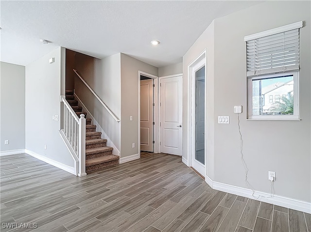 4564 Almada Ln, Wesley Chapel, FL 33543 - entryway with wood finished floors, baseboards, stairs, and recessed lighting