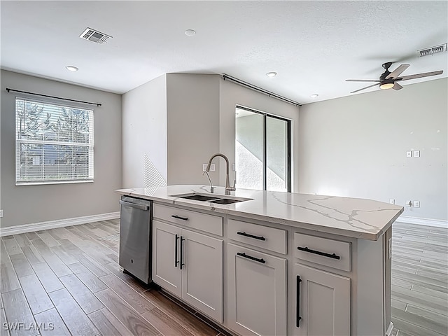 4564 Almada Ln, Wesley Chapel, FL 33543 - kitchen featuring dishwasher, a sink, ceiling fan, baseboards, and light wood-type flooring