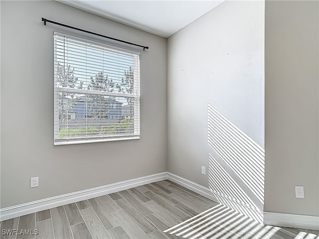 4564 Almada Ln, Wesley Chapel, FL 33543 - empty room with baseboards and wood tiled floors