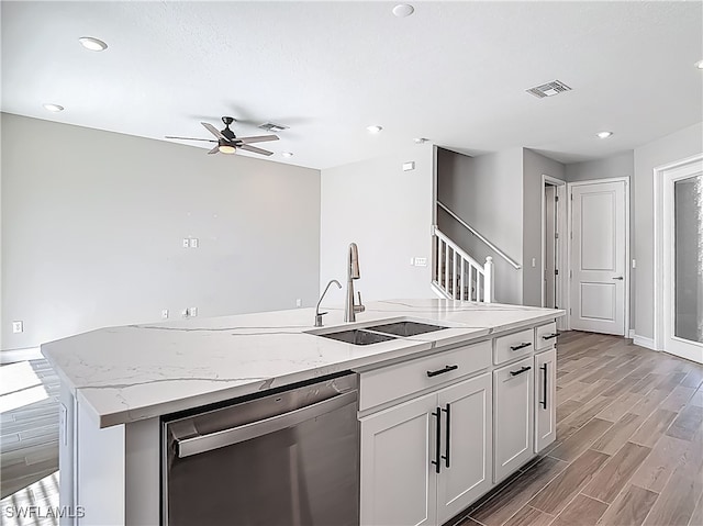 4564 Almada Ln, Wesley Chapel, FL 33543 - kitchen with dishwasher, a sink, light wood-type flooring, a ceiling fan, and an island with sink
