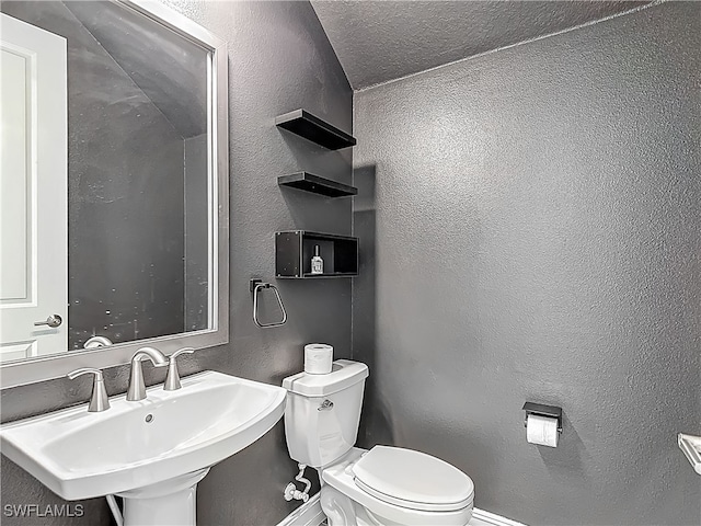 4564 Almada Ln, Wesley Chapel, FL 33543 - bathroom featuring toilet, a sink, a textured wall, and baseboards