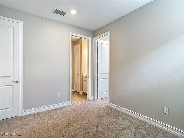 4564 Almada Ln, Wesley Chapel, FL 33543 - unfurnished bedroom featuring carpet flooring, baseboards, recessed lighting, and ensuite bath