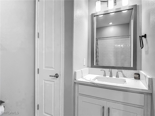 4564 Almada Ln, Wesley Chapel, FL 33543 - full bathroom with vanity, a textured wall, and a shower