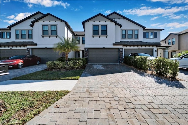 4564 Almada Ln, Wesley Chapel, FL 33543 - view of property with decorative driveway, a garage, and stucco siding