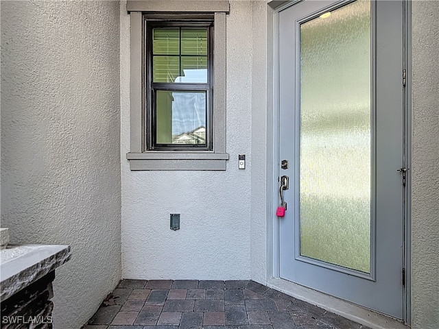 4564 Almada Ln, Wesley Chapel, FL 33543 - view of exterior entry featuring stucco siding