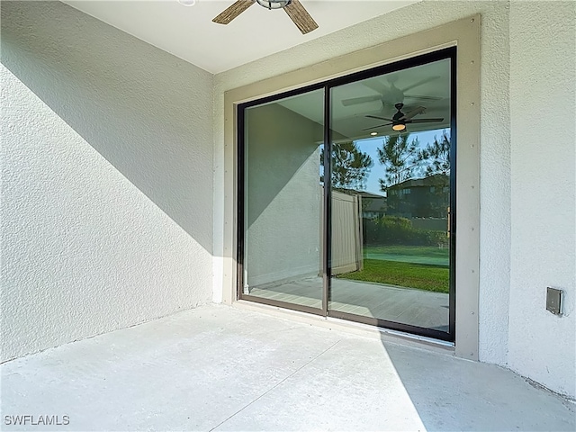 4564 Almada Ln, Wesley Chapel, FL 33543 - view of exterior entry with a ceiling fan, a patio area, and stucco siding