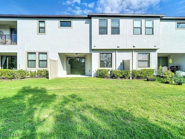 4564 Almada Ln, Wesley Chapel, FL 33543 - back of house with stucco siding and a lawn
