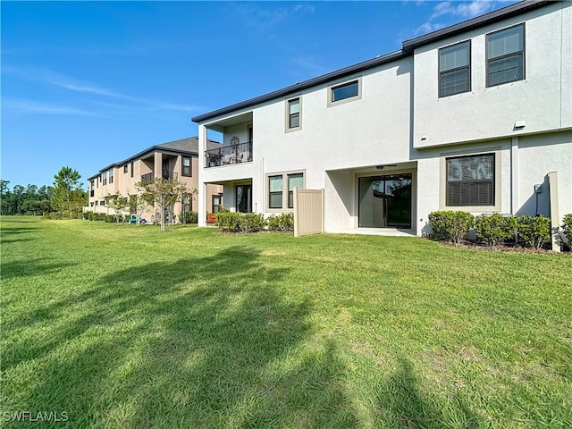 4564 Almada Ln, Wesley Chapel, FL 33543 - back of property with stucco siding and a lawn