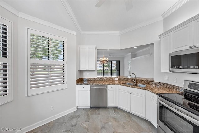 2432 Ravenna Blvd Unit 4, Naples, FL 34109 - kitchen with appliances with stainless steel finishes, plenty of natural light, ornamental molding, dark stone counters, and white cabinetry