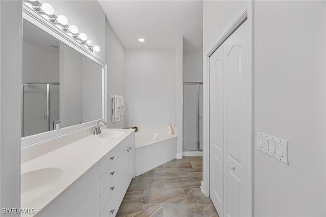 2432 Ravenna Blvd Unit 4, Naples, FL 34109 - full bathroom featuring a closet, a bath, a stall shower, double vanity, and marble finish flooring