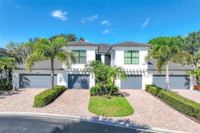 2432 Ravenna Blvd Unit 4, Naples, FL 34109 - view of front of house with stucco siding and driveway